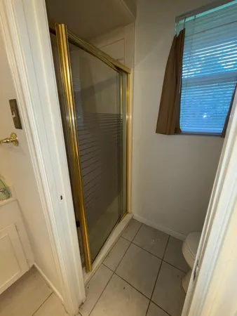 a bathroom with a shower and a mirror
