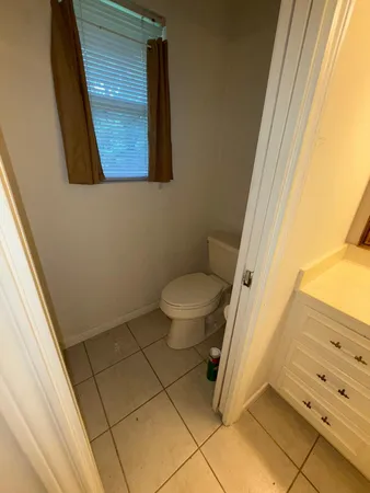 a bathroom with a toilet and a shower curtain