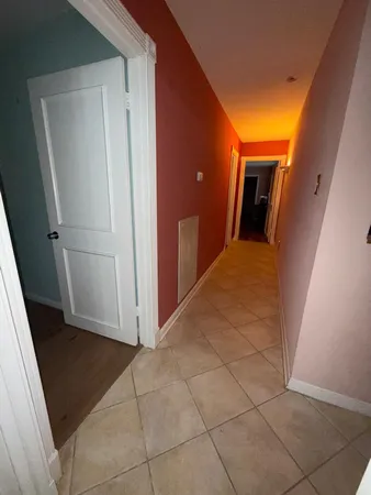 a view of a utility room with closet and mirror