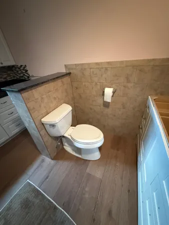 a bathroom with a sink mirror vanity and toilet