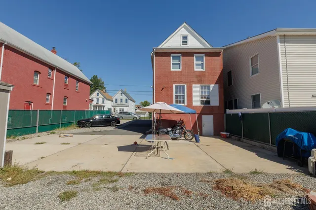 a view of a patio with a table and chairs under an umbrella