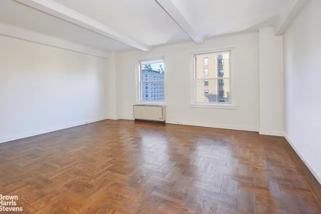 a living room with furniture and floor to ceiling window