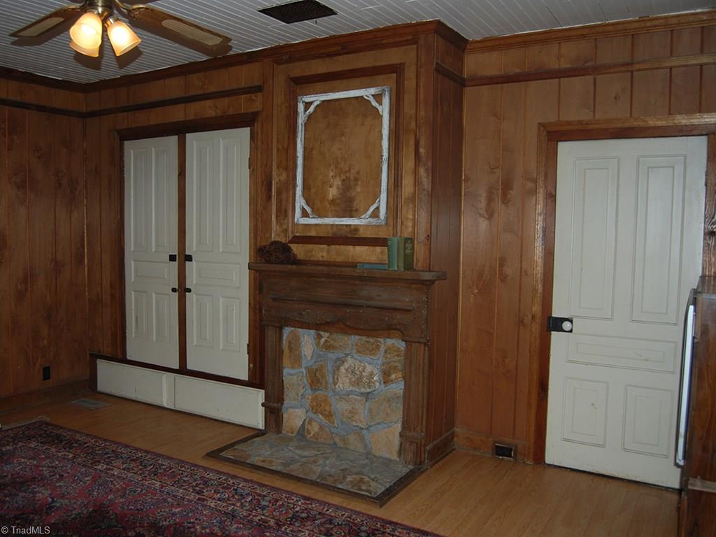 429 Hege Road Lexington, NC 27295 - Photo 14 of 29 The original fireplace in den rocked in to accommodate a gas stove could be opened up to use for built-in wood stove or for an open fireplace. Closet with original doors and hardware with large drawers underneath add storage.