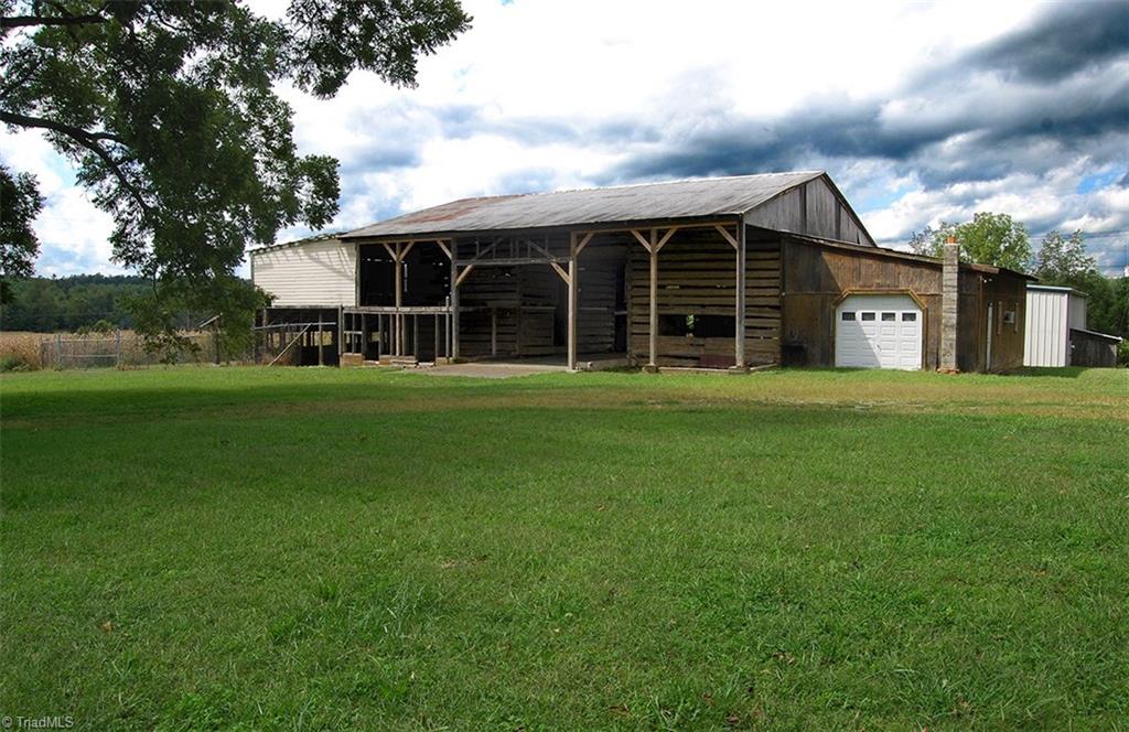 429 Hege Road Lexington, NC 27295 - Photo 3 of 29 Massive 235 yr. old log barn with attached garage has unlimited potential. Center has concrete flooring and approx. 16 ft. height clearance is potential parking for recreational vehicles, farm equipment etc. with plenty of room on each side for horses, cattle, or whatever you need to store.
