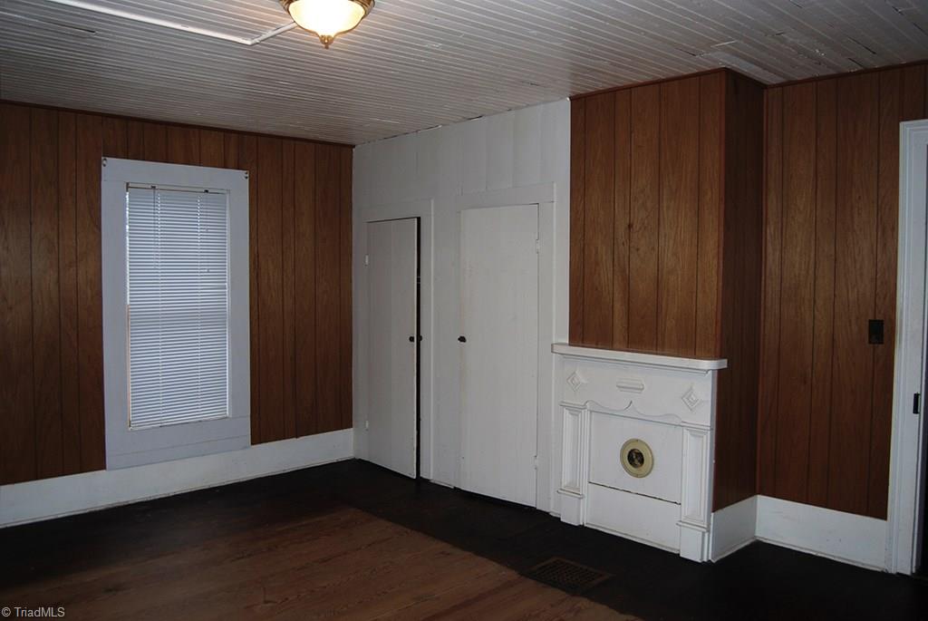 429 Hege Road Lexington, NC 27295 - Photo 21 of 29 Upstairs bedroom #1 with original mantel, closets, beadboard ceilings and hardwood floors.