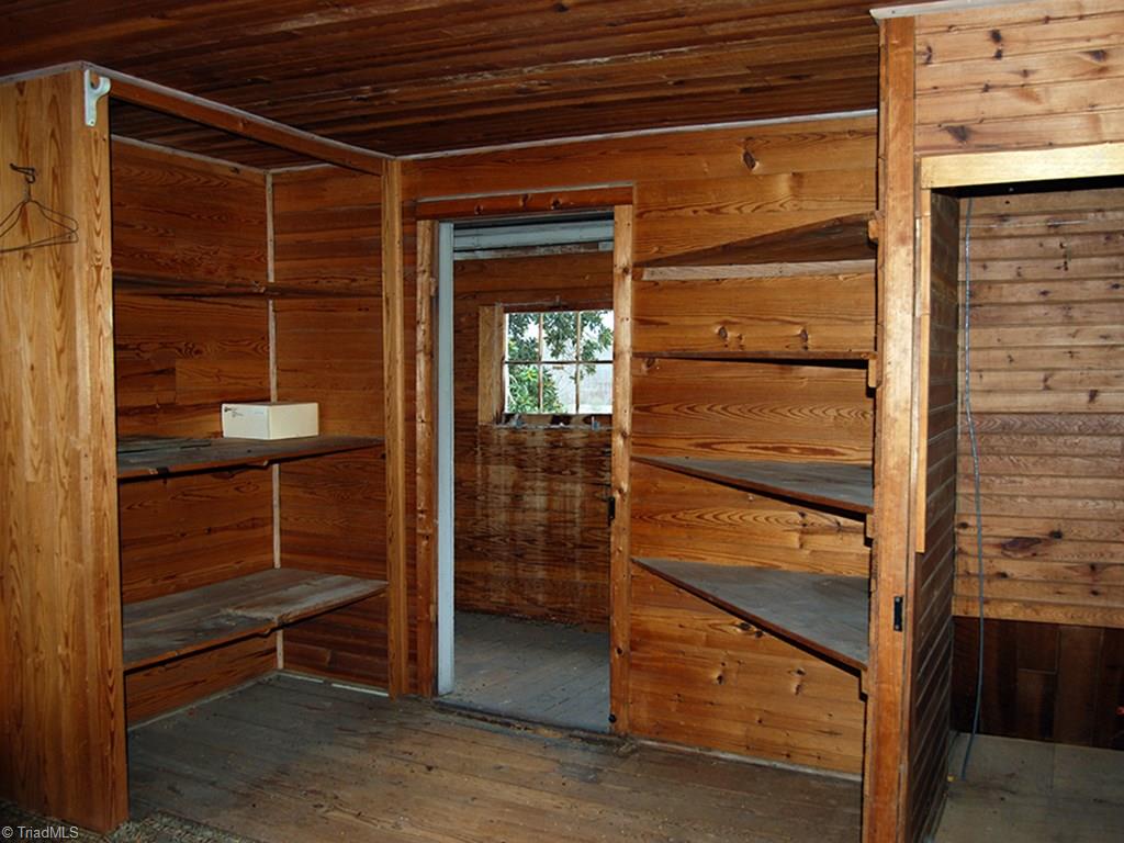 429 Hege Road Lexington, NC 27295 - Photo 24 of 29 One of two upstairs storage rooms with access through enclosed balcony has original hardwood walls and floors could potentially be converted to living area.