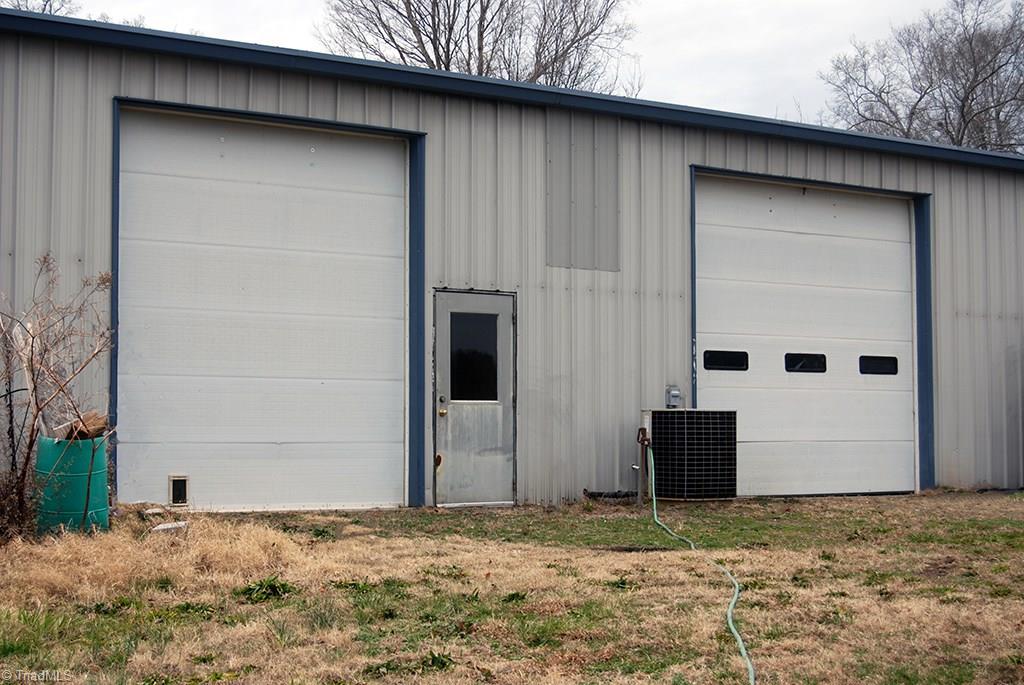 429 Hege Road Lexington, NC 27295 - Photo 26 of 29 Commercial building, separately zoned commercial, features 12 ft. garage doors. Has hot water heater, full bath, and office. Great to use as your own workshop, storage for farm equipment, your own business, or rent it out for extra income!