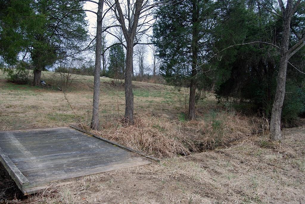 429 Hege Road Lexington, NC 27295 - Photo 29 of 29 Sturdy tractor bridge crosses babbling brook that is fed by as many as 3 springs.