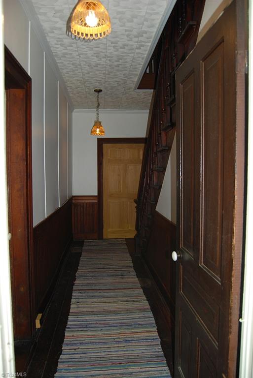 429 Hege Road Lexington, NC 27295 - Photo 6 of 29 Large entryway with original hardwood floors and wainscoting. Original beadboard is under ceiling tiles. Just refinish the floors and replace new front door with a unique antique front door to take it back to its original glory!