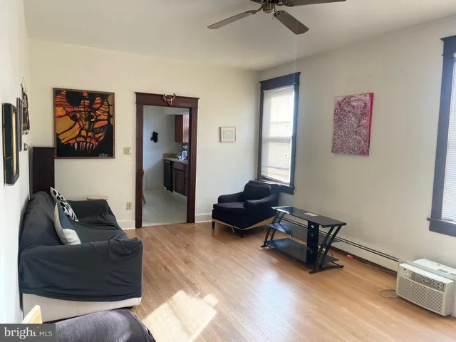 a living room with furniture and a air conditioner vent