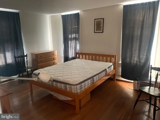 a bed sitting in a bedroom next to a window