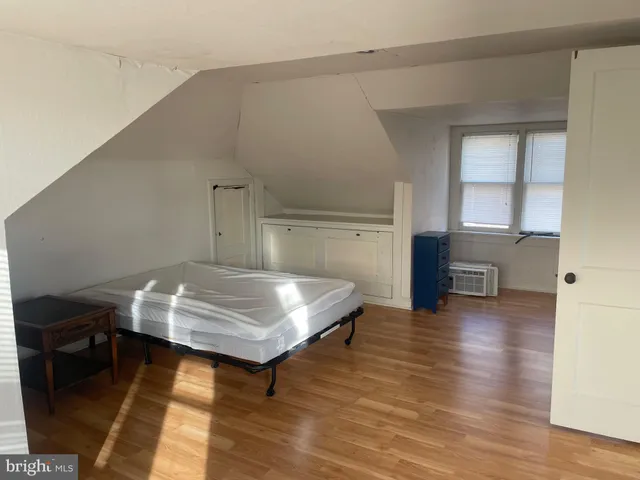 a room with pool table and wooden floor