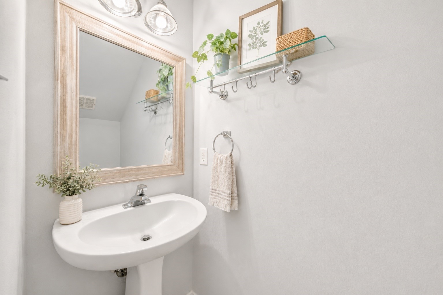 38 Musgrove Place Spring, TX 77382 - Photo 12 of 36 Bright half bath featuring pedestal sink, oversized framed mirror, and sleek glass shelf with hooks.