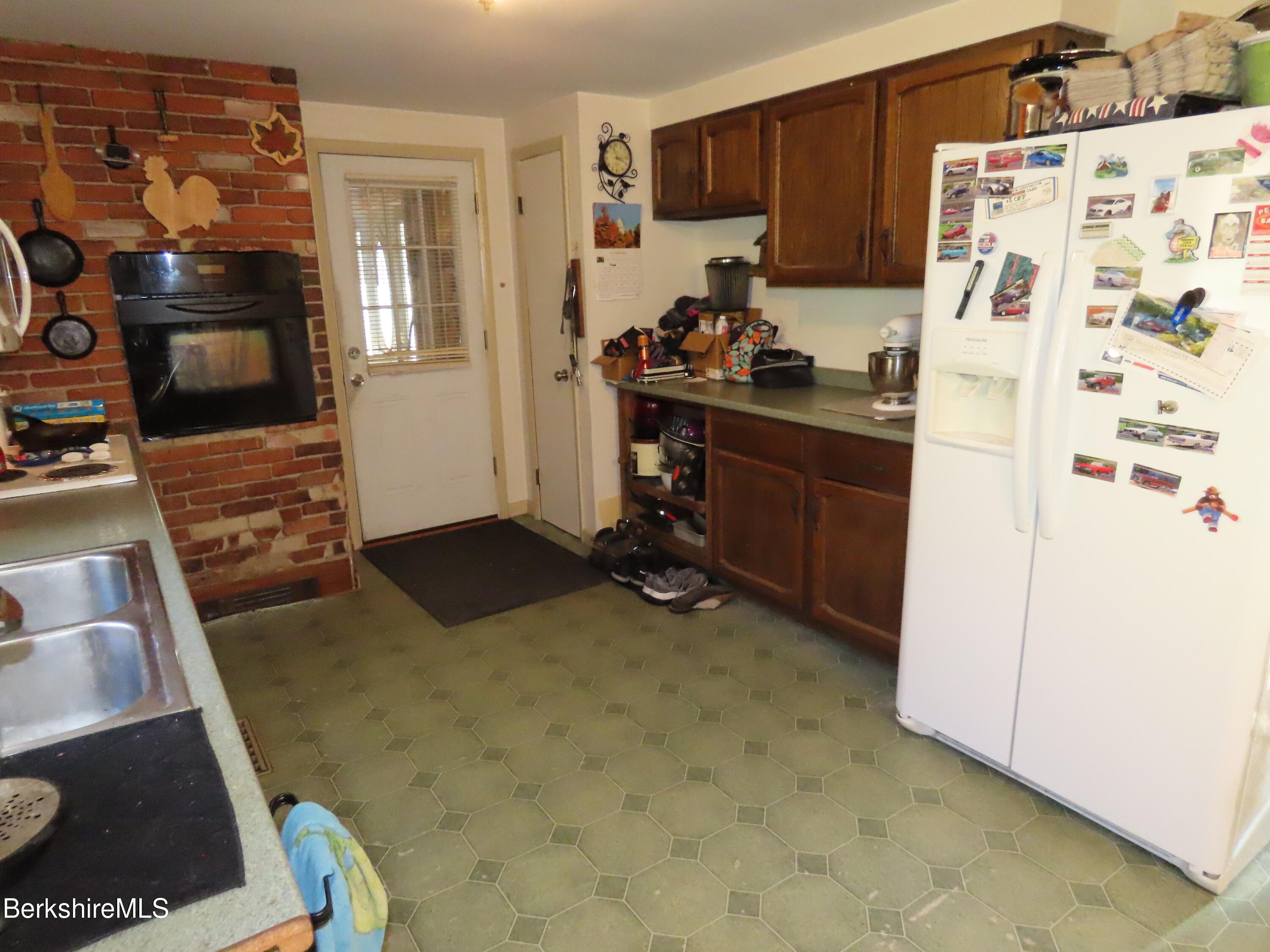 669 Main Road Savoy, MA 01256 - Photo 11 of 36 a kitchen with a refrigerator and a stove