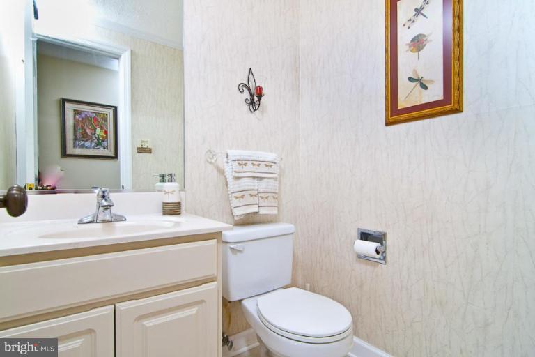 383 Yorkshire Lane Riva, MD 21140 - Photo 7 of 21 a bathroom with a toilet sink and mirror