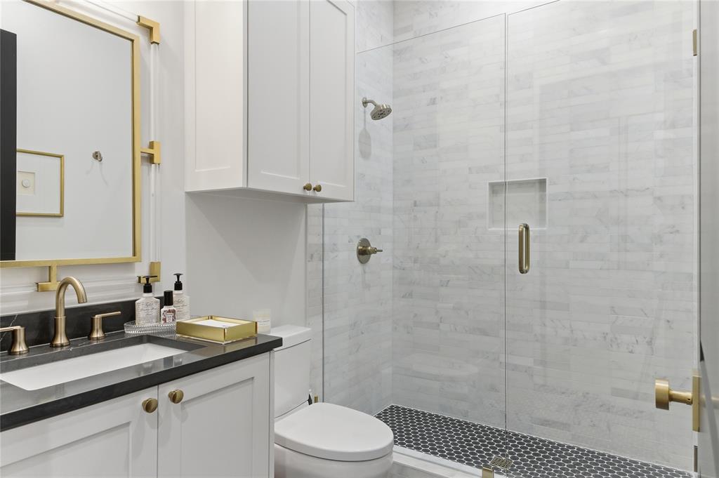 320 O Connor Ridge Boulevard, Unit 22 Irving, TX 75038 - Photo 27 of 34 a bathroom with a granite countertop sink a toilet a shower and a mirror