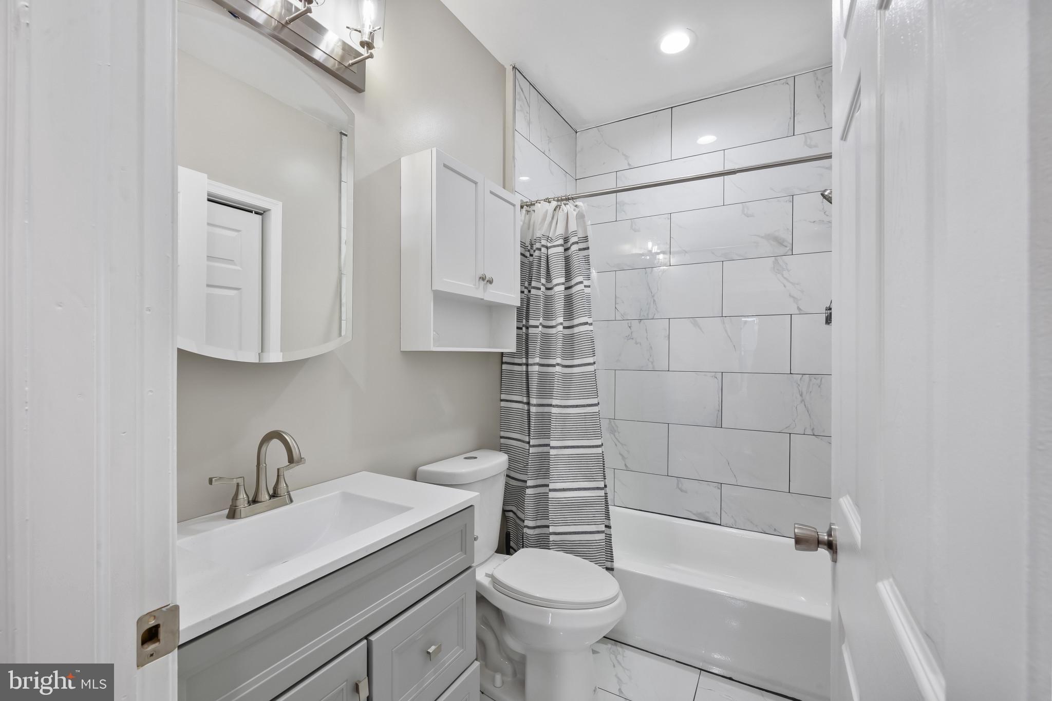 2202 East Chase Street Baltimore, MD 21213 - Photo 16 of 33 a bathroom with a sink toilet and shower