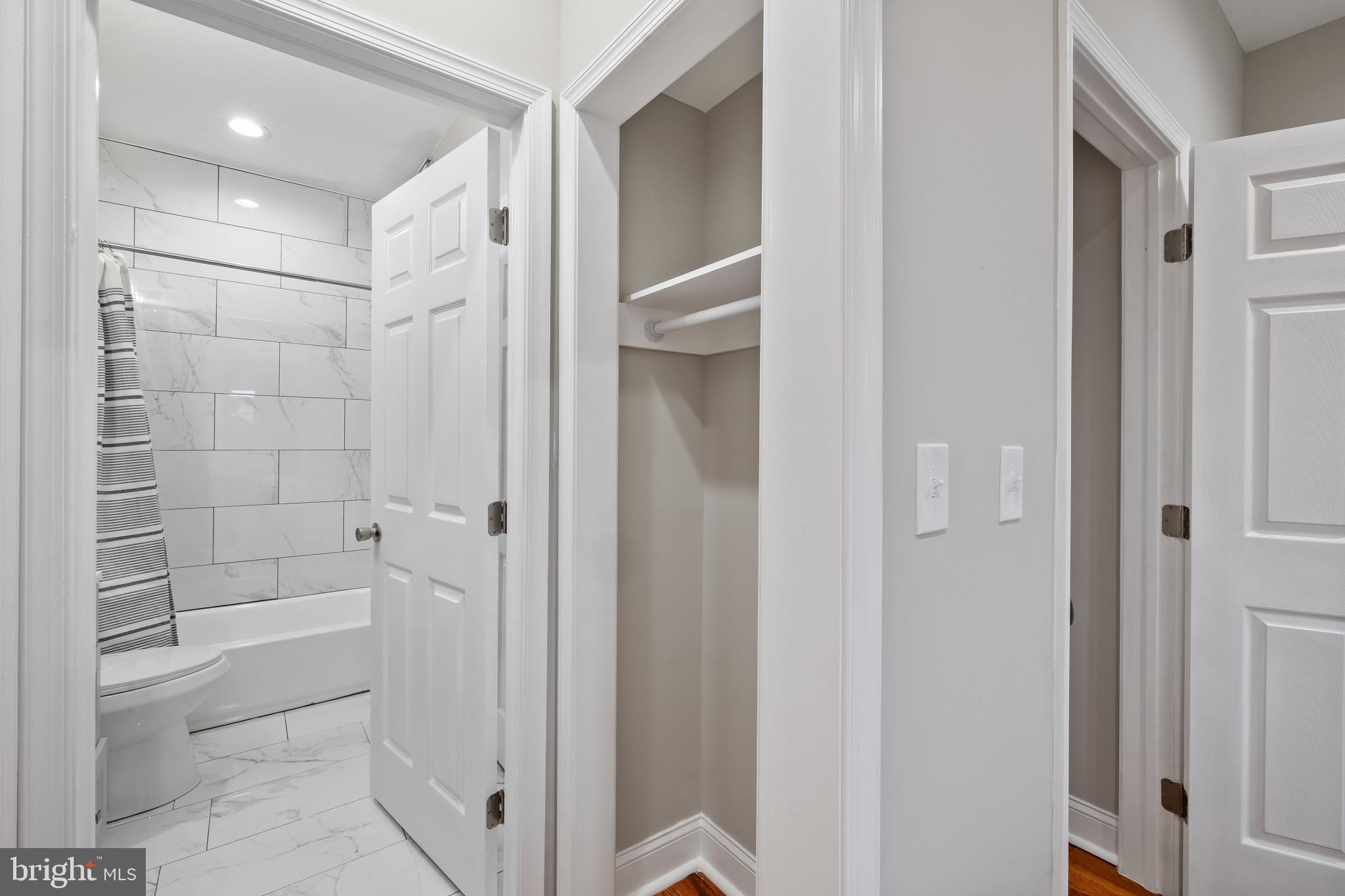 2202 East Chase Street Baltimore, MD 21213 - Photo 18 of 33 a bathroom with a shower and a toilet