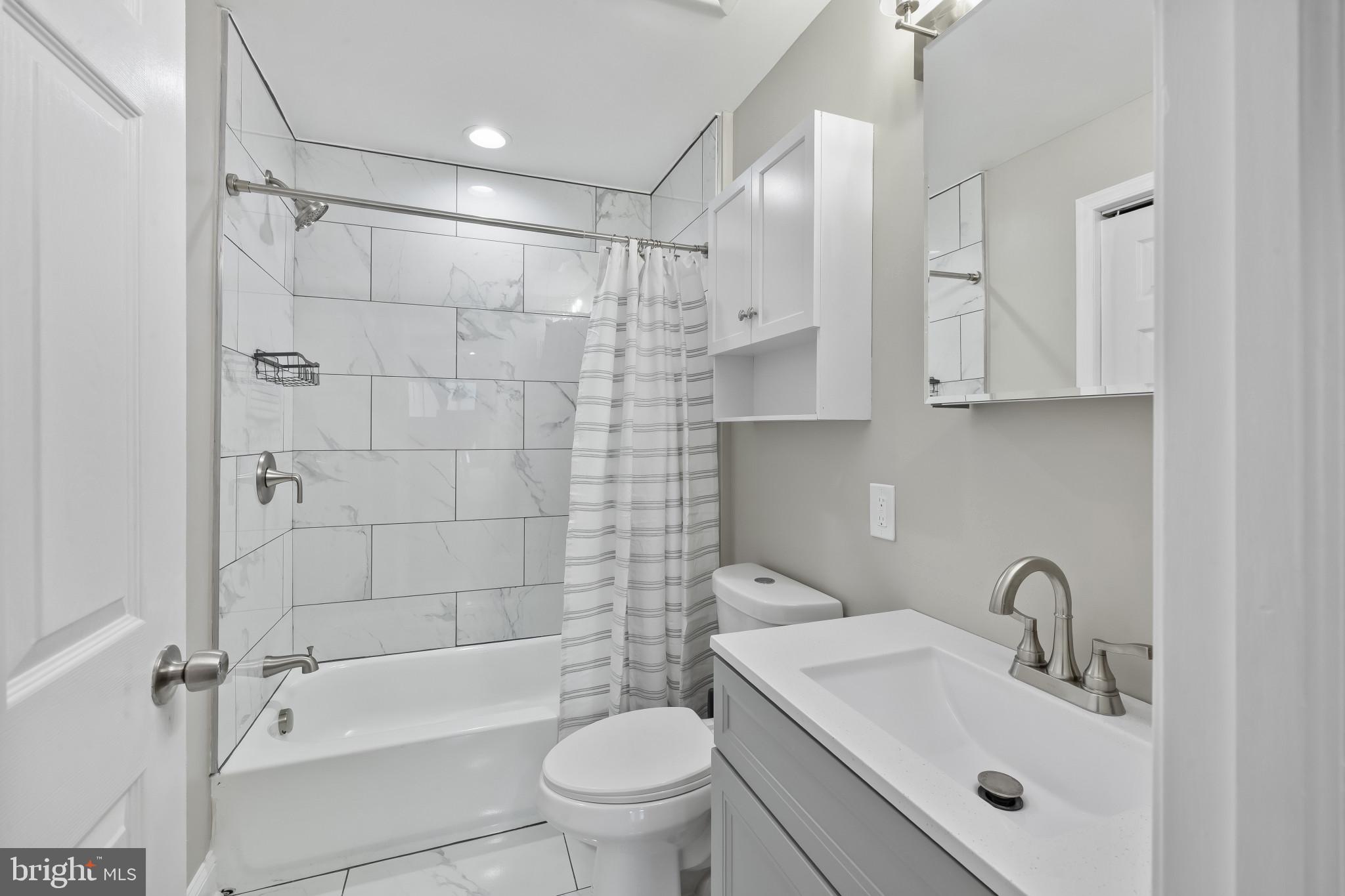 2202 East Chase Street Baltimore, MD 21213 - Photo 26 of 33 a bathroom with a sink toilet and shower