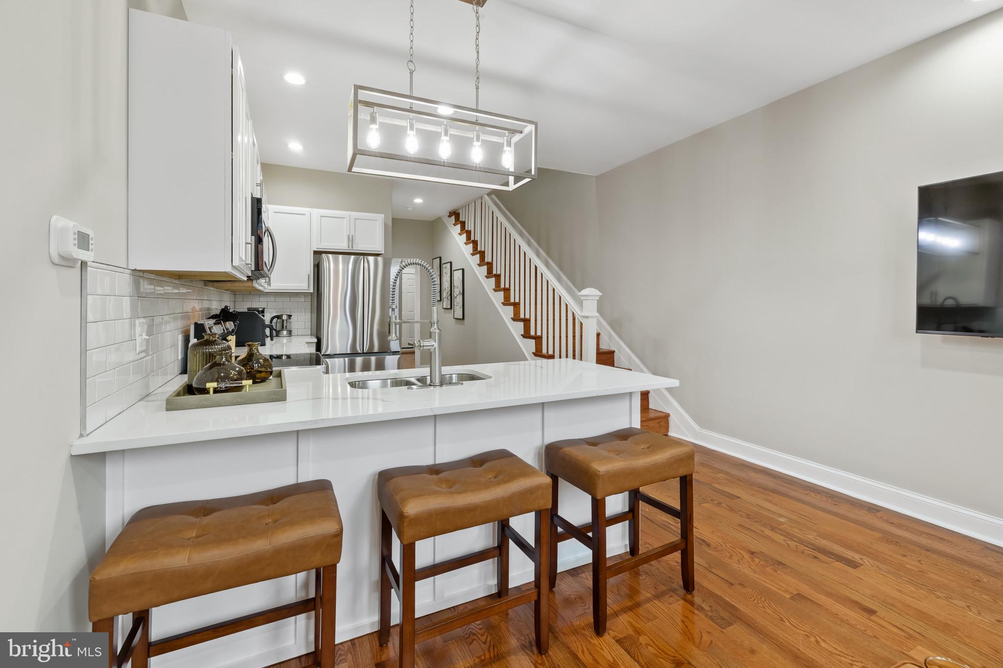 2202 East Chase Street Baltimore, MD 21213 - Photo 6 of 33 a view of a dining room with furniture and wooden floor
