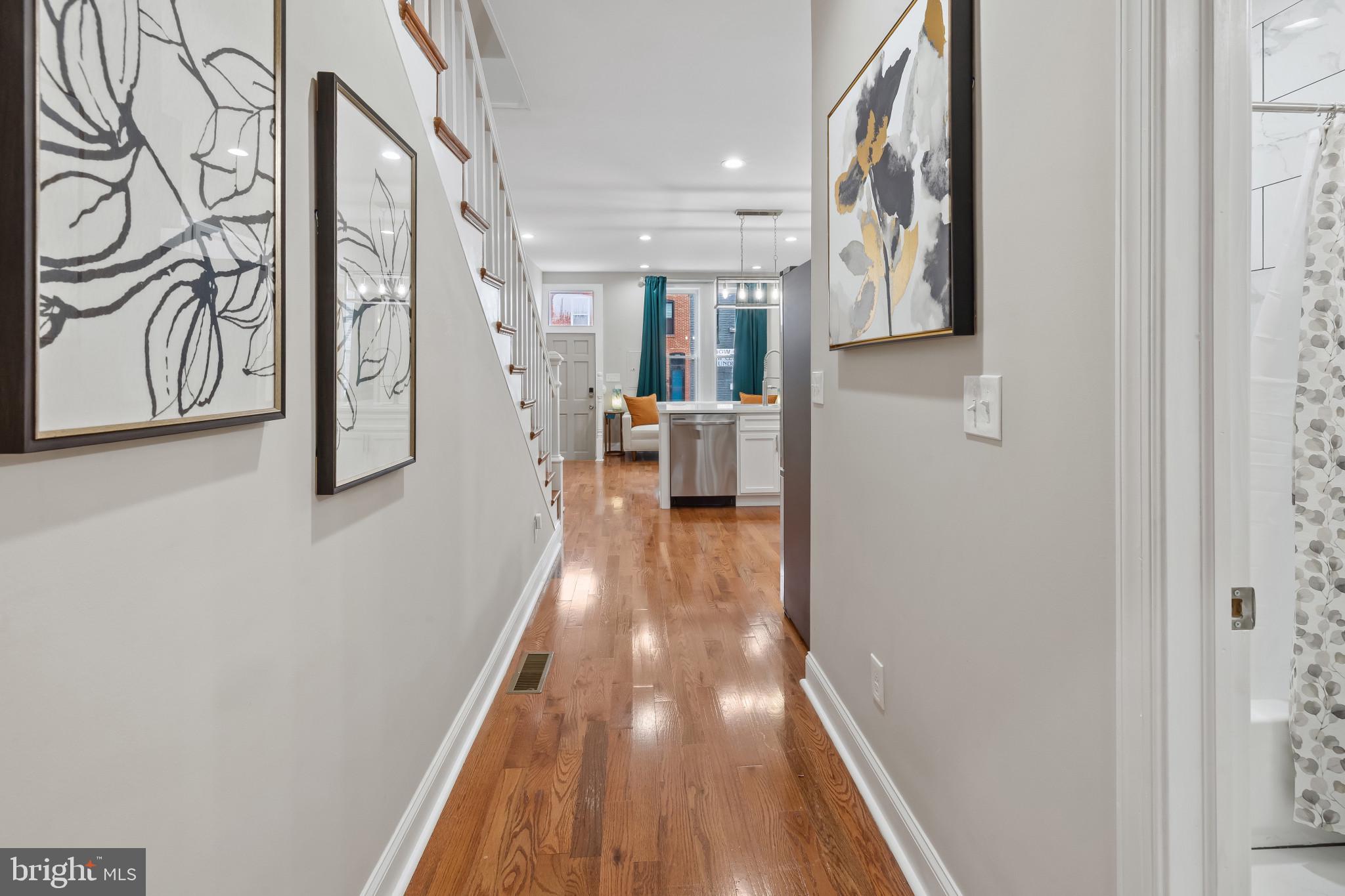 2202 East Chase Street Baltimore, MD 21213 - Photo 7 of 33 a view of a hallway with wooden floor and staircase