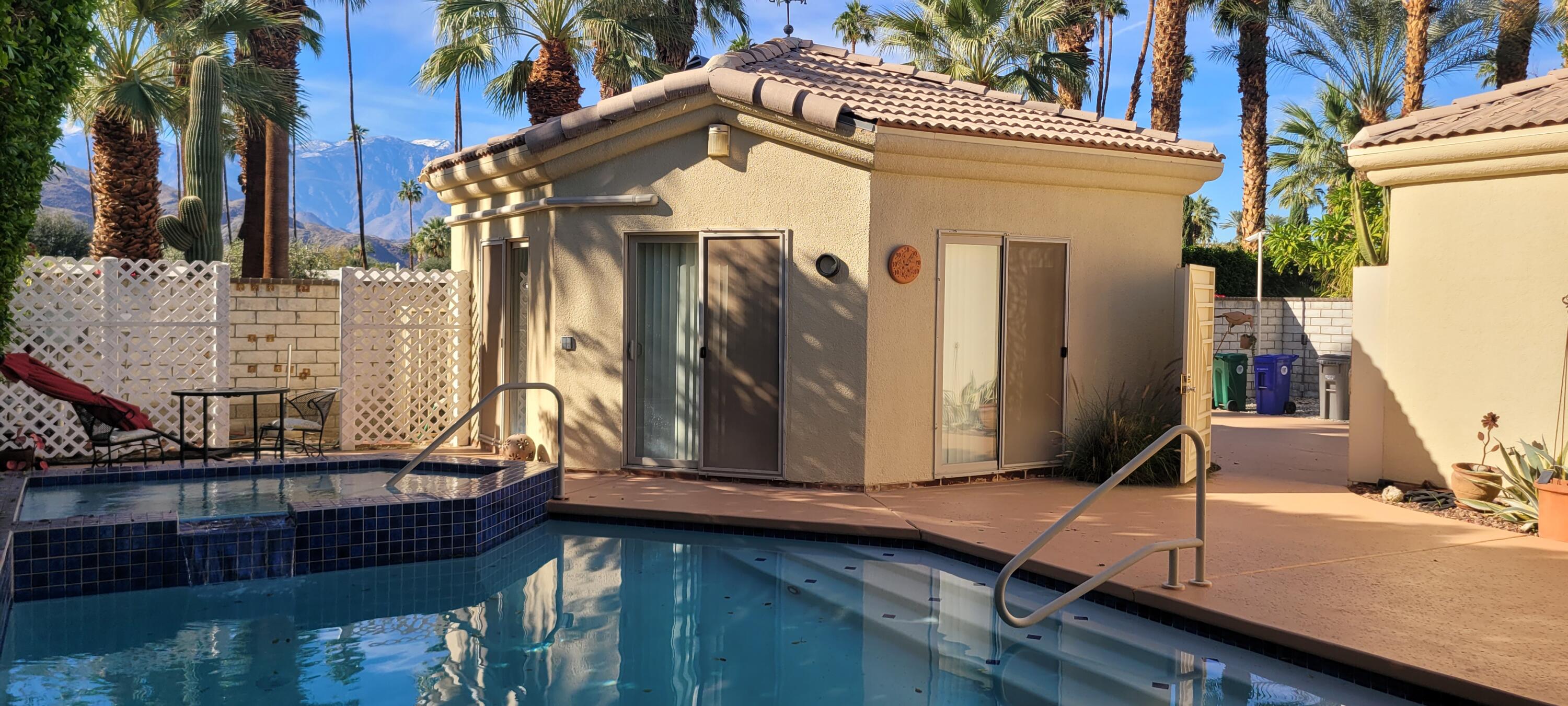 39914 Morningsprings Road Rancho Mirage, CA 92270 - Photo 15 of 54 a view of a house with a door and wooden bench