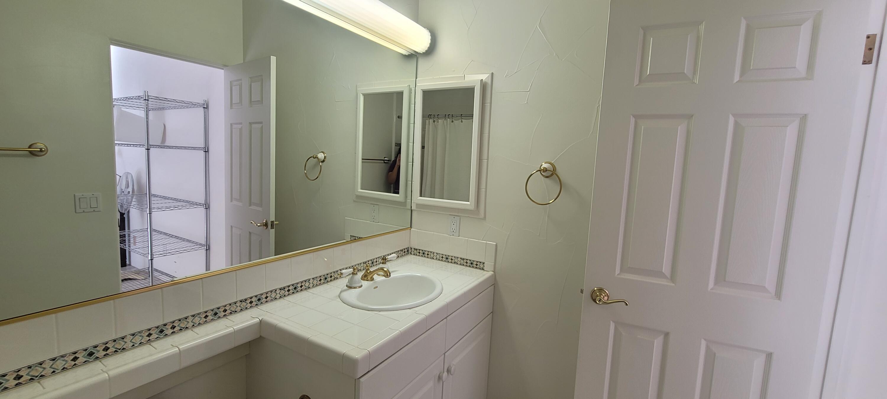 39914 Morningsprings Road Rancho Mirage, CA 92270 - Photo 17 of 54 a bathroom with a sink and mirror