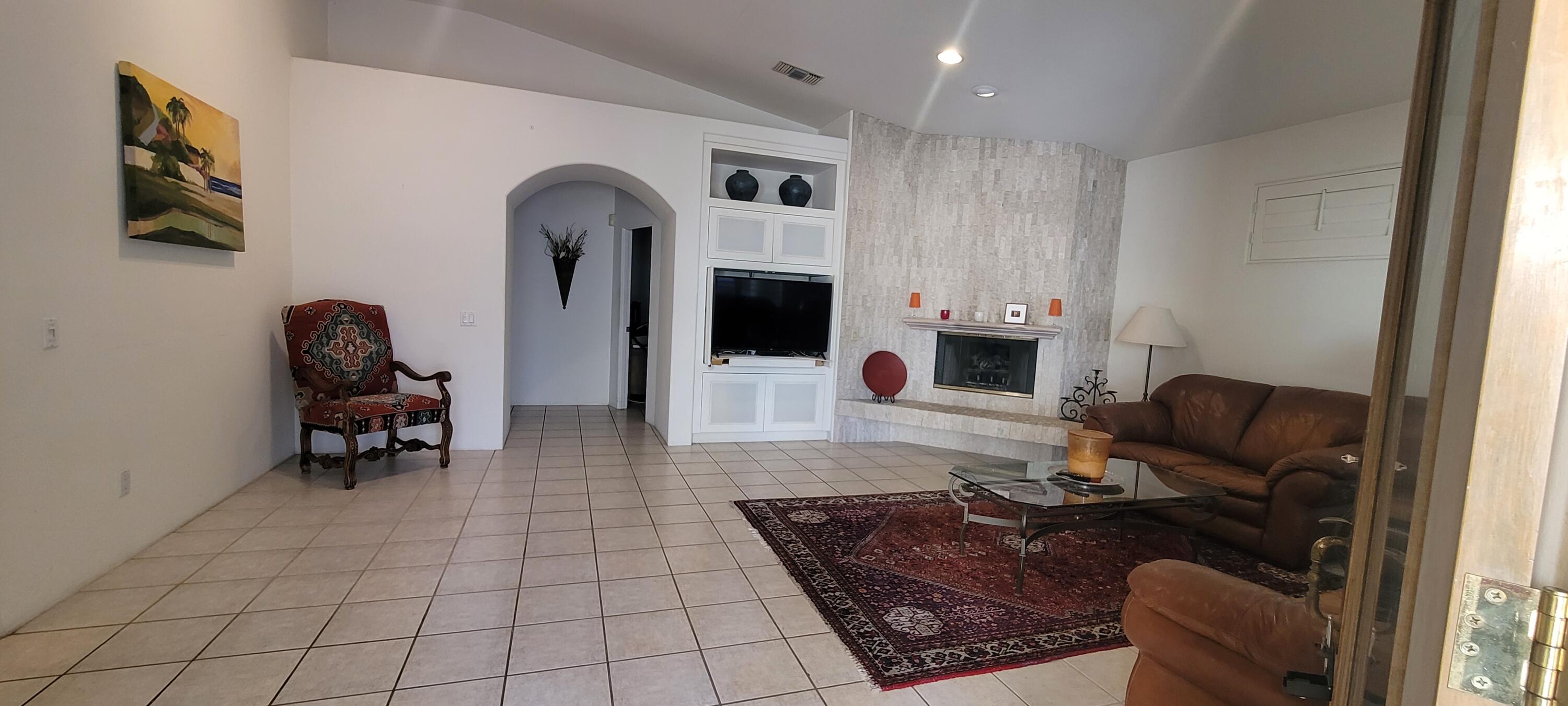 39914 Morningsprings Road Rancho Mirage, CA 92270 - Photo 22 of 54 a living room with furniture and a fireplace