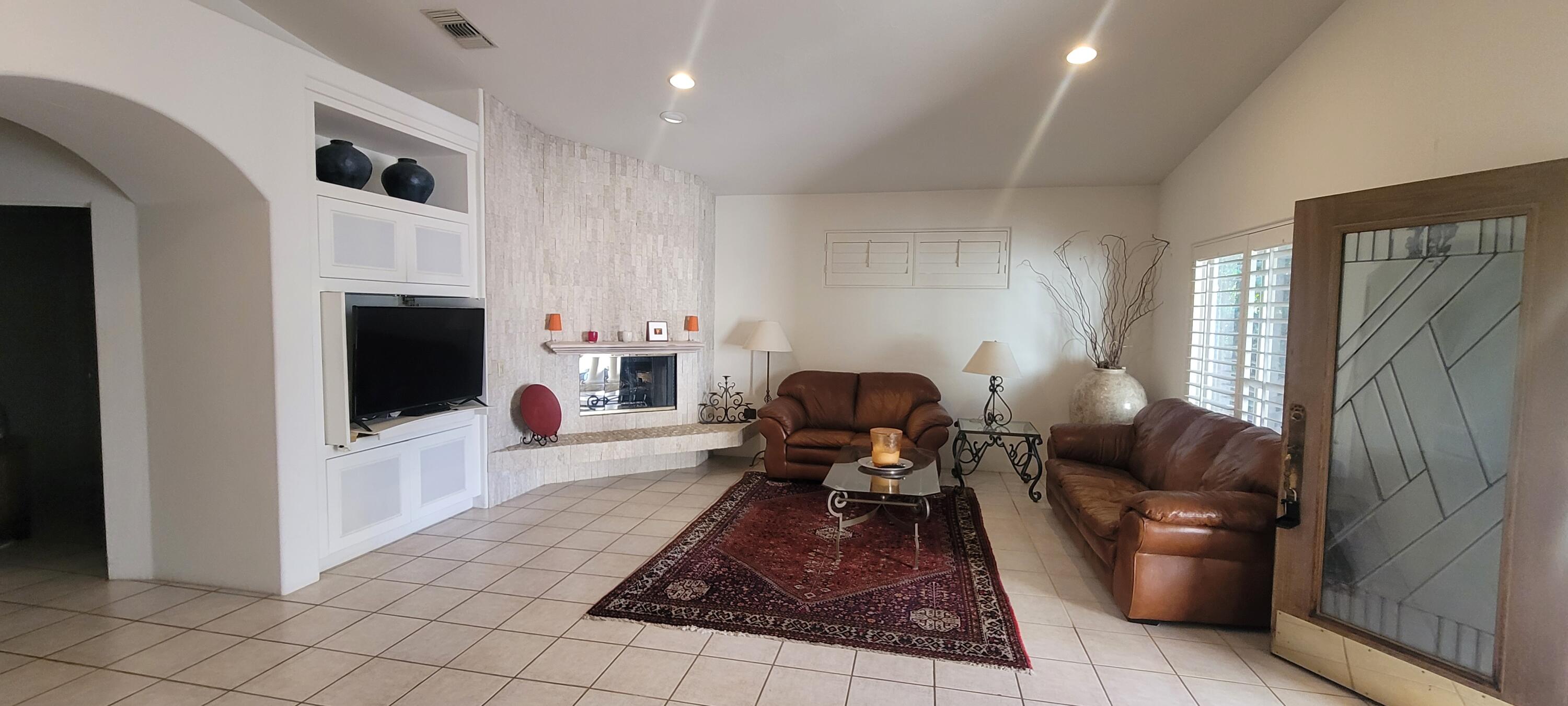 39914 Morningsprings Road Rancho Mirage, CA 92270 - Photo 23 of 54 a living room with furniture and a flat screen tv