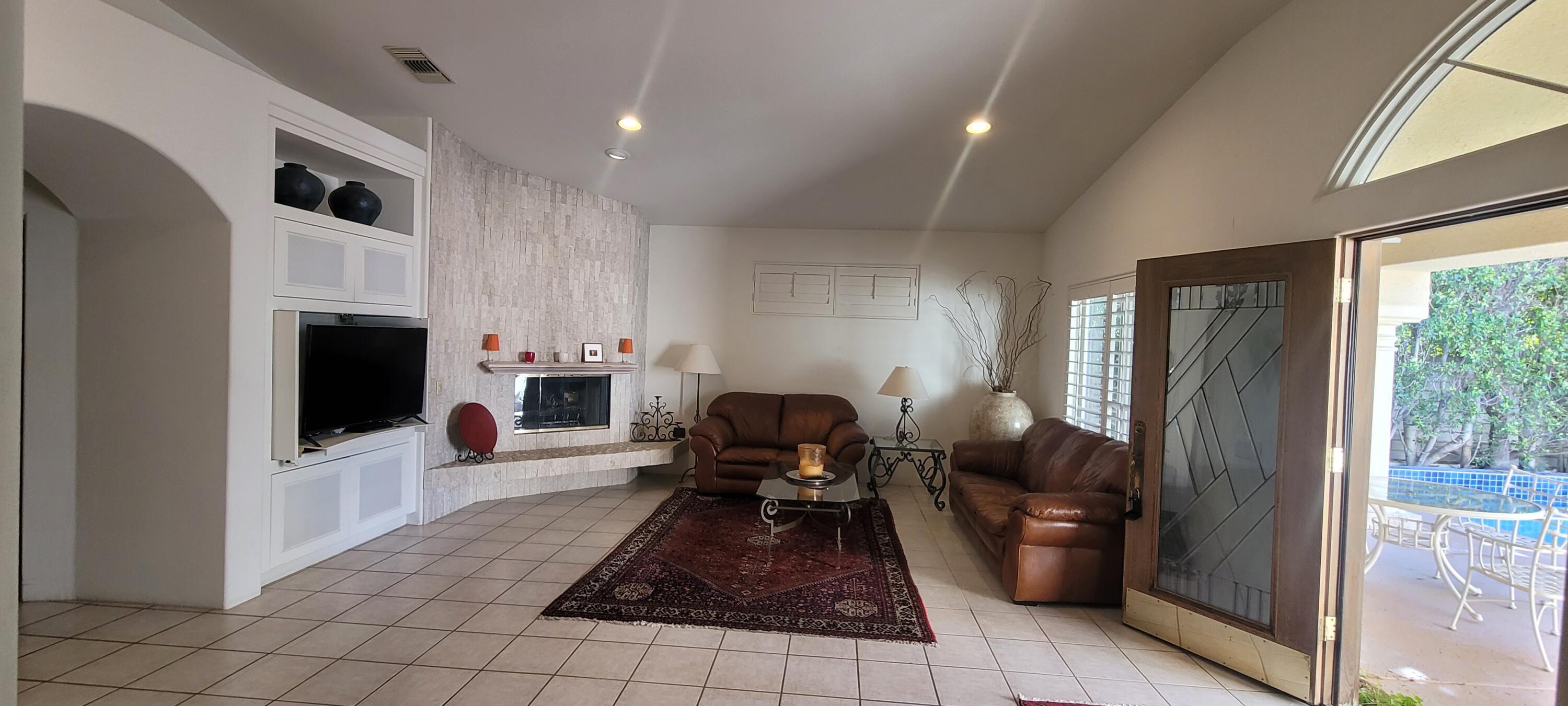 39914 Morningsprings Road Rancho Mirage, CA 92270 - Photo 24 of 54 a living room with furniture and a flat screen tv