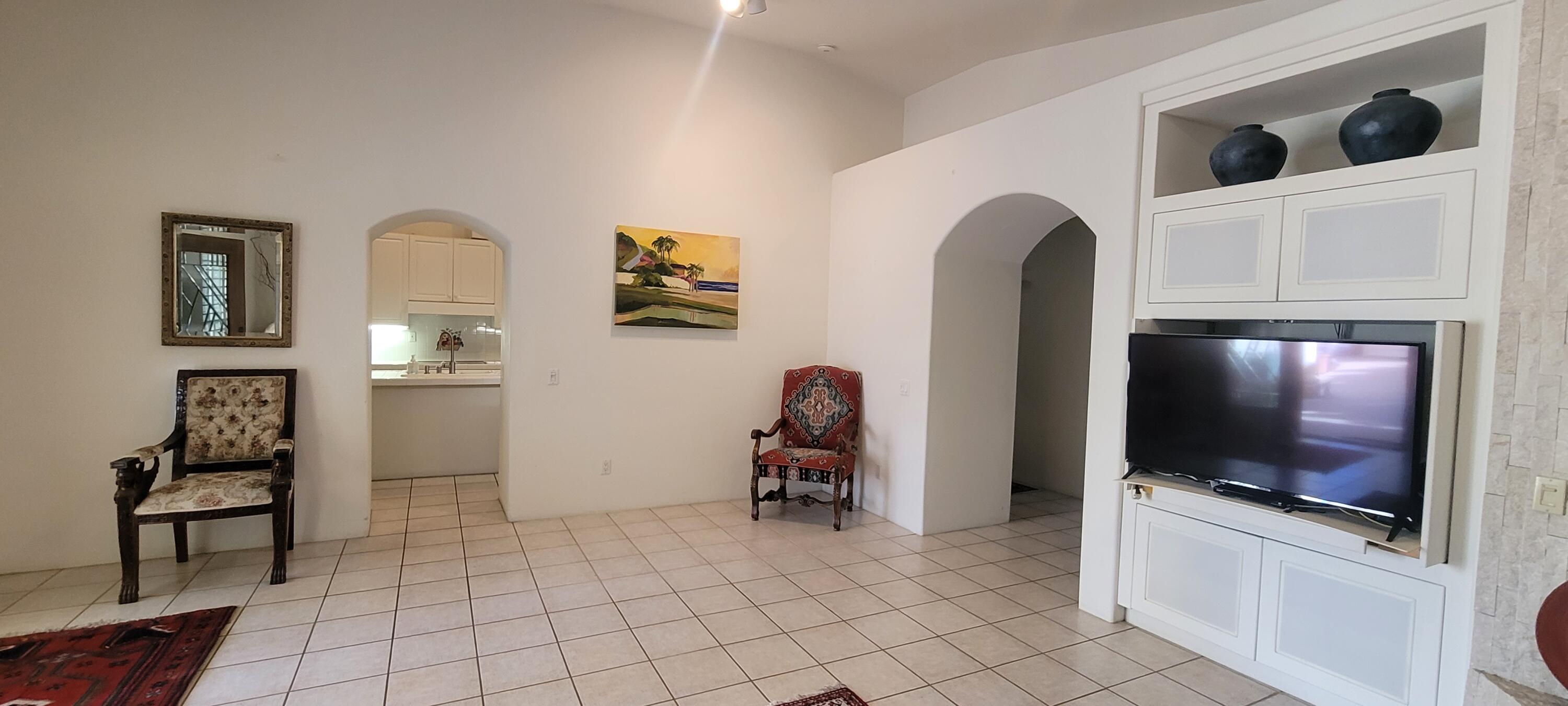 39914 Morningsprings Road Rancho Mirage, CA 92270 - Photo 27 of 54 a living room with furniture and a flat screen tv