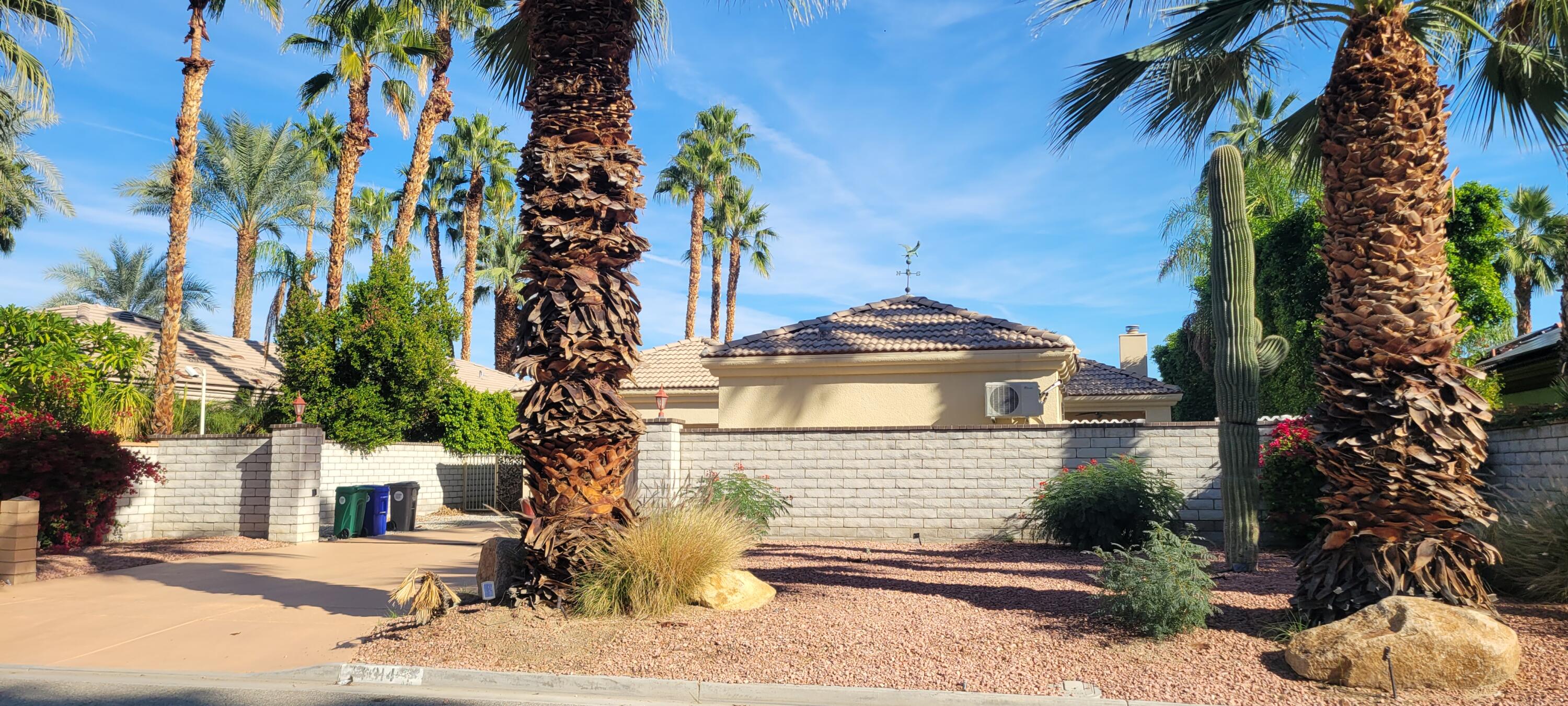 39914 Morningsprings Road Rancho Mirage, CA 92270 - Photo 3 of 54 a front view of a house with a yard