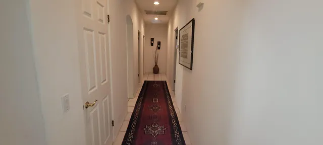 a bedroom with a bed and a flat tv screen on dresser