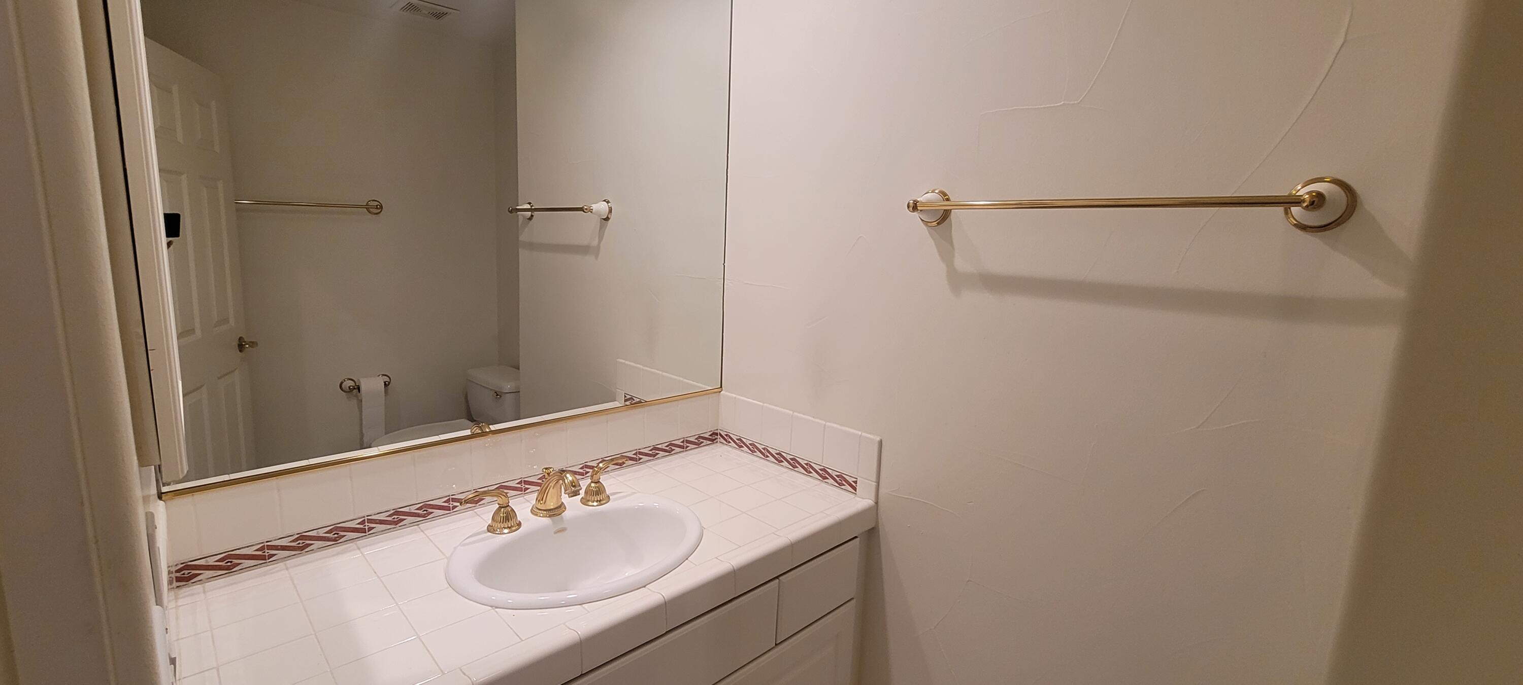 39914 Morningsprings Road Rancho Mirage, CA 92270 - Photo 46 of 54 a bathroom with a sink and a mirror