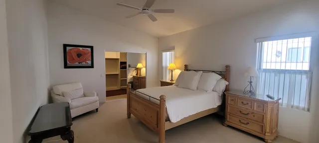 a spacious bathroom with a tub sink and mirror