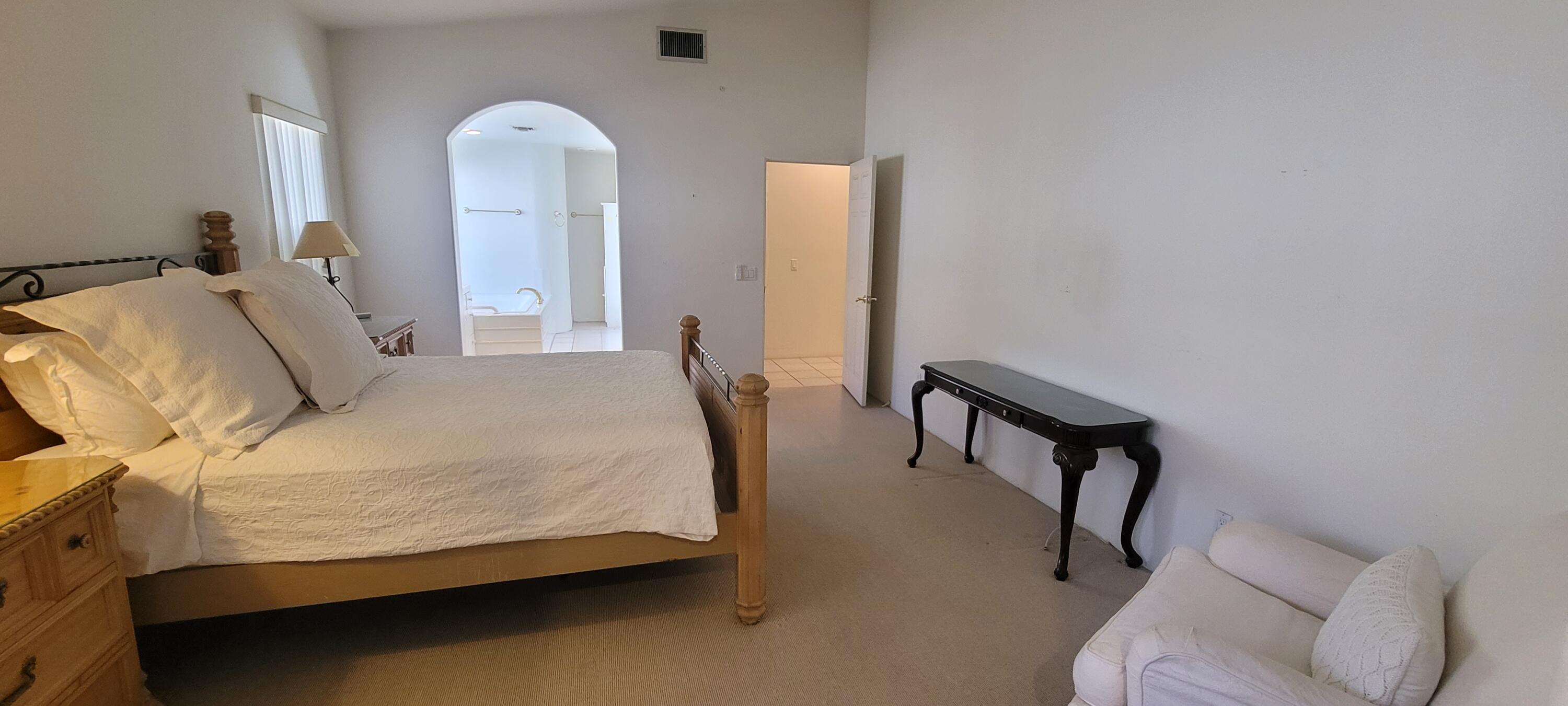 39914 Morningsprings Road Rancho Mirage, CA 92270 - Photo 50 of 54 a bedroom with a bed and a chair