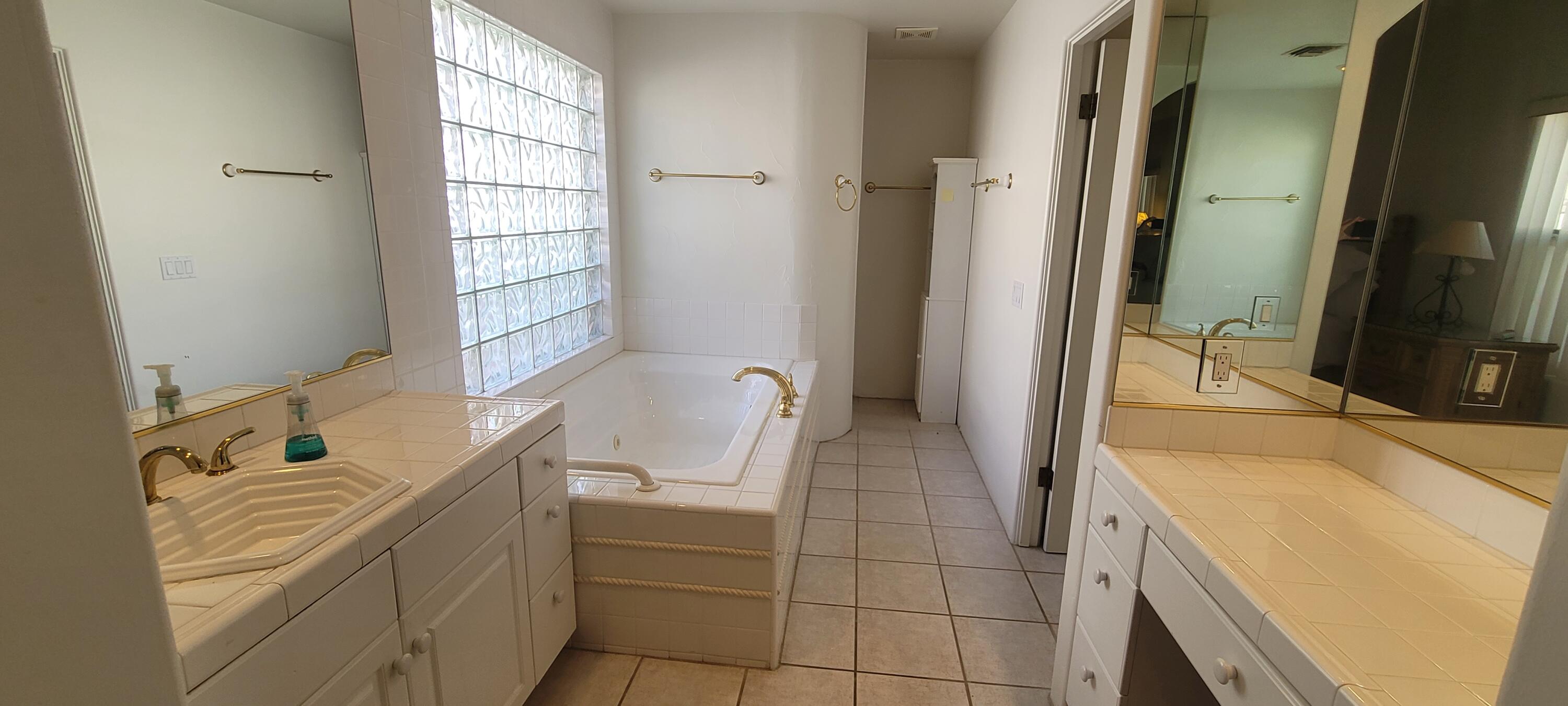 39914 Morningsprings Road Rancho Mirage, CA 92270 - Photo 51 of 54 a spacious bathroom with a tub sink and mirror