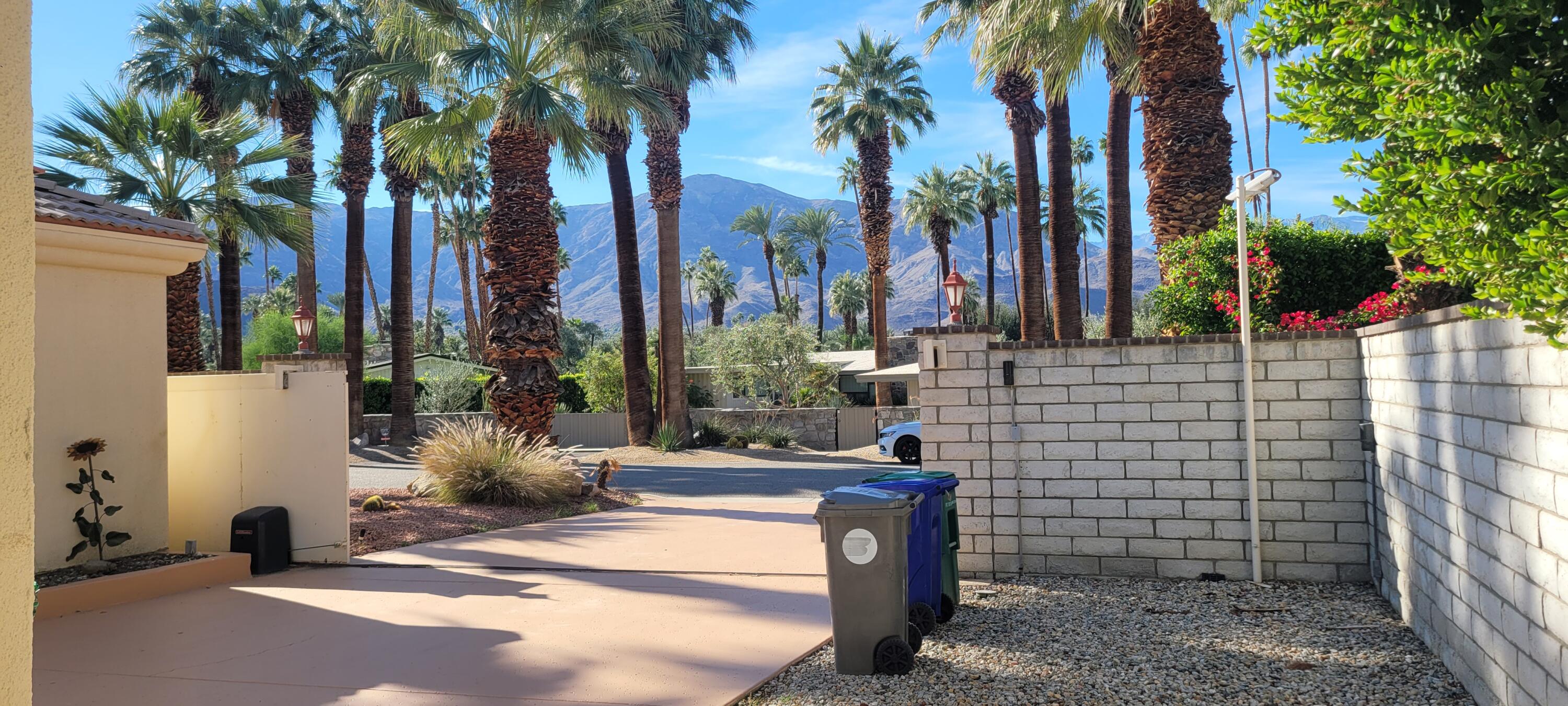 39914 Morningsprings Road Rancho Mirage, CA 92270 - Photo 6 of 54 a view of a backyard with palm trees