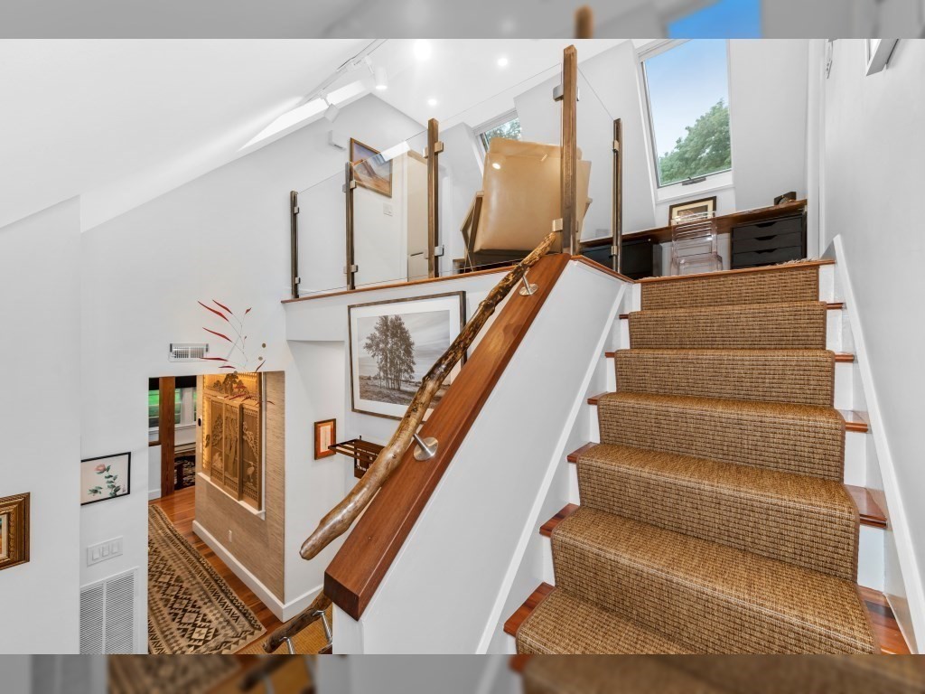 76 Ober Road, Unit 76 Newton, MA 02459 - Photo 11 of 32 a view of staircase with lots of frames on wall and windows