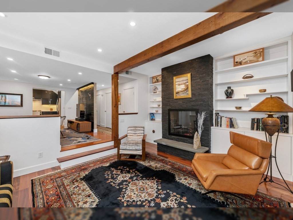 76 Ober Road, Unit 76 Newton, MA 02459 - Photo 4 of 32 a living room with furniture and a fireplace