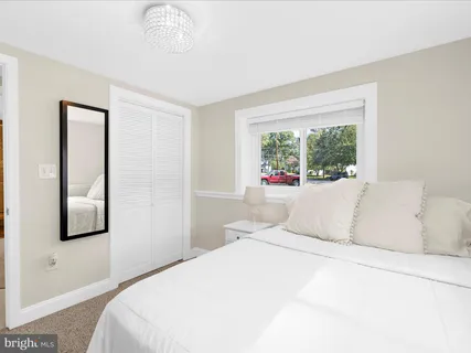 a bathroom with a granite countertop sink a mirror and a shower