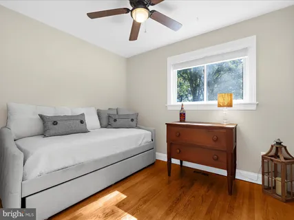 a view of a livingroom with a cabinet and a ceiling fan
