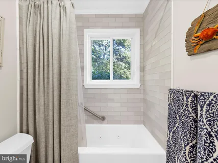 a bathroom with a sink mirror vanity and toilet