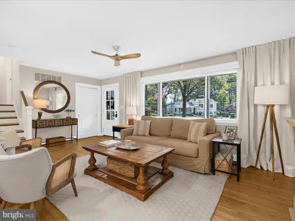 a living room with furniture a rug and a large window