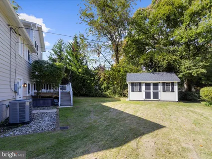 an aerial view of ocean and residential houses with outdoor space