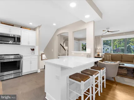 a kitchen with a sink stove and microwave