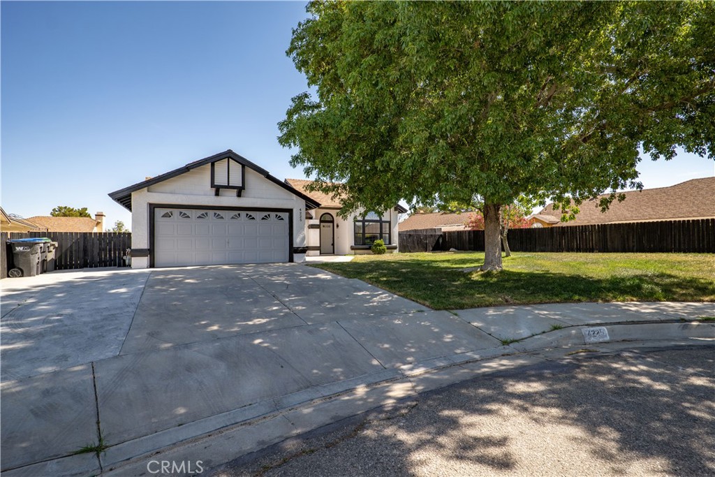 a front view of a house with a yard and a garage