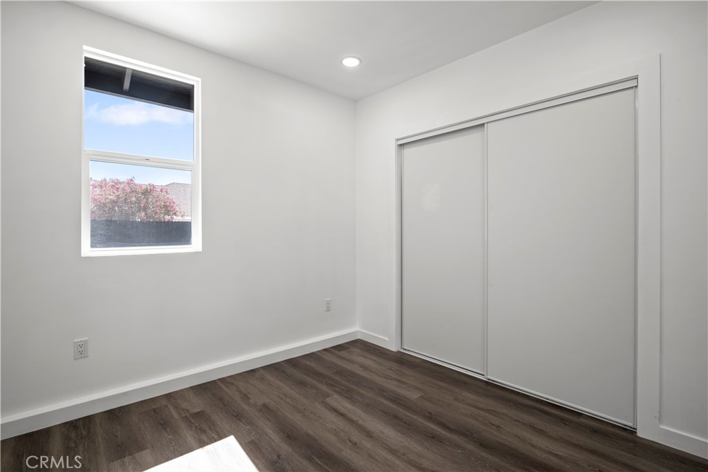 4225 Saddleback Road Palmdale, CA 93552 - Photo 30 of 61 an empty room with wooden floor and closet