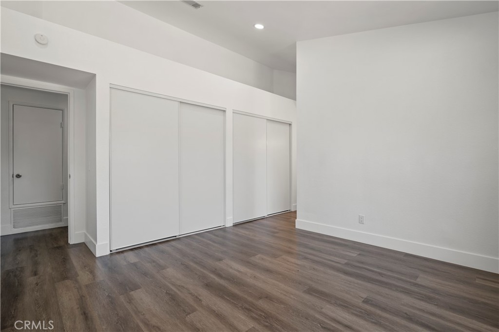 4225 Saddleback Road Palmdale, CA 93552 - Photo 33 of 61 a view of an empty room with wooden floor