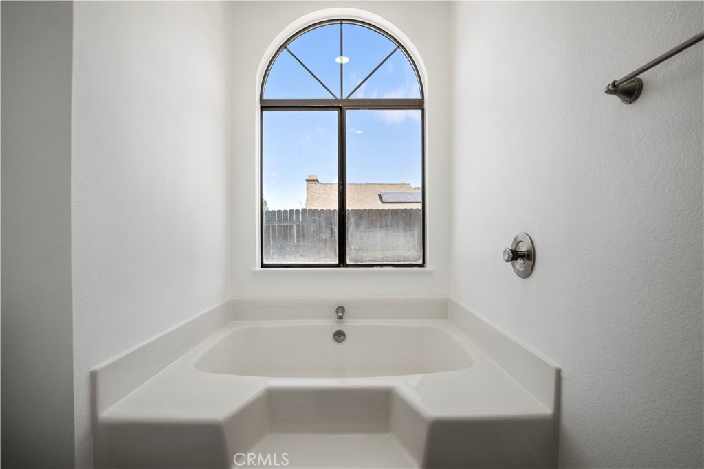4225 Saddleback Road Palmdale, CA 93552 - Photo 36 of 61 a bathroom with a tub and a window
